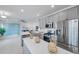 Contemporary kitchen with stainless steel appliances, grey cabinets, and a large island with white countertops at 5728 Skytop Dr, Lithia, FL 33547