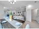 Open-concept layout features a modern kitchen with stainless steel appliances, a dining area, and a living room at 5728 Skytop Dr, Lithia, FL 33547