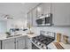 A modern kitchen featuring stainless steel appliances, white countertops, and a gas range at 5728 Skytop Dr, Lithia, FL 33547