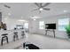 Open-concept living room with bar seating, lots of light, and ceiling fan at 5728 Skytop Dr, Lithia, FL 33547