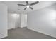 Loft area with gray carpeting, white walls, and ceiling fan at 5728 Skytop Dr, Lithia, FL 33547