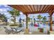 Community pool with lounge chairs, tables and splash pad on a sunny day at 5728 Skytop Dr, Lithia, FL 33547