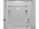 Modern bathtub and shower combination with built-in shelves, and a shower curtain, providing comfort at 5728 Skytop Dr, Lithia, FL 33547