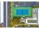 Aerial view of tennis court, shuffleboard, kayak storage, parking and tiki hut with mature trees on the property at 5840 30Th S Ave # 305, Gulfport, FL 33707