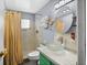 Bathroom featuring bright vanity with a glass vessel sink and tiled shower at 5840 30Th S Ave # 305, Gulfport, FL 33707