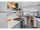 Open kitchen with stainless appliances, sleek countertops, and a view into the living area at 5840 30Th S Ave # 305, Gulfport, FL 33707