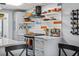 Stylish kitchen featuring updated countertops, modern appliances, and floating shelves at 5840 30Th S Ave # 305, Gulfport, FL 33707