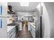 A modern kitchen with stainless appliances and long view to the front door at 5840 30Th S Ave # 305, Gulfport, FL 33707