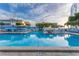 Resort-style swimming pool with plenty of lounge seating and lush tropical landscaping at 5840 30Th S Ave # 305, Gulfport, FL 33707