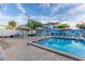 Large swimming pool with chair seating, lounge areas, lush tropical landscaping, and beachfront access at 5840 30Th S Ave # 305, Gulfport, FL 33707