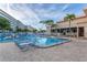Large swimming pool with chair seating and lush tropical landscaping and beachfront access at 5840 30Th S Ave # 305, Gulfport, FL 33707