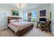 Bedroom interior complete with a decorative bed, desk, and bright windows at 628 Cleveland St # 907, Clearwater, FL 33755