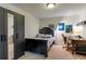 A bedroom features a striking black bed frame complemented by a well-lit desk and ample storage at 628 Cleveland St # 907, Clearwater, FL 33755