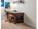 A well-lit desk is adorned with planetary artwork and a shelf filled with multimedia at 628 Cleveland St # 907, Clearwater, FL 33755