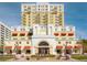 Low angle view of the exterior of a light yellow and white 13-story Station Square building on a bright day at 628 Cleveland St # 907, Clearwater, FL 33755