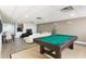 A game room boasts a billiards table, plush seating, and a dining area for social gatherings at 628 Cleveland St # 907, Clearwater, FL 33755