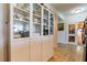 Bright hallway with tiled floor featuring full cabinets and a view to a doorway to another room at 628 Cleveland St # 907, Clearwater, FL 33755
