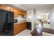 A modern kitchen features stainless appliances, sleek granite countertops, and warm wooden cabinets at 628 Cleveland St # 907, Clearwater, FL 33755