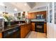 Cozy kitchen featuring granite countertops, dark appliances, and built-in display cabinets at 628 Cleveland St # 907, Clearwater, FL 33755