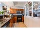 Well-equipped kitchen showcasing black appliances, a gray rug and custom wood cabinets at 628 Cleveland St # 907, Clearwater, FL 33755