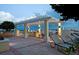 Relaxing rooftop terrace featuring elegant pergola, lounge chairs, and an outdoor kitchen with city views at 628 Cleveland St # 907, Clearwater, FL 33755