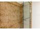 Walk-in shower featuring mosaic tile surround and glass door at 628 Cleveland St # 907, Clearwater, FL 33755