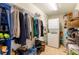 A walk-in closet contains wire shelving, hanging rods, and stacked washer and dryer at 628 Cleveland St # 907, Clearwater, FL 33755