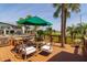 Relaxing deck area with outdoor seating and a green umbrella, surrounded by picturesque views at 710 S Brevard Ave, Tampa, FL 33606