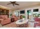 Bright living room featuring tile floors, ceiling fan, and sliding doors to an outdoor seating area at 710 S Brevard Ave, Tampa, FL 33606