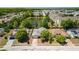 Aerial view of a beautiful house with a pond in the backyard and lush landscaping at 8329 Broken Willow Ln, Port Richey, FL 34668