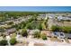 Aerial view showing a house with a pond in a scenic neighborhood with beautiful trees at 8329 Broken Willow Ln, Port Richey, FL 34668