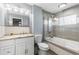 Updated bathroom featuring a shower and tub combination, white vanity, and modern fixtures at 8329 Broken Willow Ln, Port Richey, FL 34668
