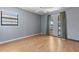 Bedroom featuring laminate floors, ceiling fan and a pair of bright windows at 8329 Broken Willow Ln, Port Richey, FL 34668