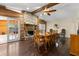 Dining room featuring wood floors, stone fireplace, wood beam ceiling, and french door to back yard at 8329 Broken Willow Ln, Port Richey, FL 34668