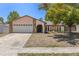 Well-maintained single-story home with stone accents, double-door entry, manicured lawn, and attached two-car garage at 8329 Broken Willow Ln, Port Richey, FL 34668