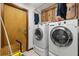Laundry room with a washer, dryer, and cabinets at 8329 Broken Willow Ln, Port Richey, FL 34668