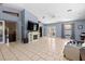 Spacious living room boasts tile floors, neutral paint, fireplace, French doors, and high ceilings at 8329 Broken Willow Ln, Port Richey, FL 34668