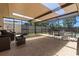Screened in patio featuring plenty of seating, outdoor furniture, and protection from insects at 8329 Broken Willow Ln, Port Richey, FL 34668