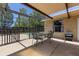 A partially shaded patio featuring an outdoor table and seating at 8329 Broken Willow Ln, Port Richey, FL 34668