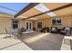 Covered patio area with outdoor seating, perfect for relaxing or entertaining at 8329 Broken Willow Ln, Port Richey, FL 34668