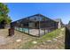 Wide angle view of the backyard pool with full enclosure and plenty of patio space at 8329 Broken Willow Ln, Port Richey, FL 34668