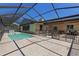 Enclosed pool and patio area with a fully screened enclosure for enjoying outdoor living at 8329 Broken Willow Ln, Port Richey, FL 34668