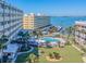 Aerial view highlighting the community's pool, pier, and access to the bay at 100 Bluff View Dr # 317A, Belleair Bluffs, FL 33770