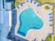 Aerial view of a community swimming pool with blue lounge chairs and well-maintained landscaping at 100 Bluff View Dr # 317A, Belleair Bluffs, FL 33770