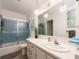 Bathroom showcasing a vanity with decorative lighting and shower-tub combination at 100 Bluff View Dr # 317A, Belleair Bluffs, FL 33770