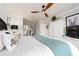 Comfortable bedroom featuring a ceiling fan and an ensuite bathroom at 100 Bluff View Dr # 317A, Belleair Bluffs, FL 33770