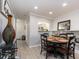 Open dining area with a wooden table, chairs, shelving, and views into the kitchen at 100 Bluff View Dr # 317A, Belleair Bluffs, FL 33770