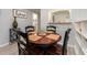Dining area features a round wooden table, chairs, and views into the kitchen and bathroom at 100 Bluff View Dr # 317A, Belleair Bluffs, FL 33770