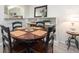 Dining area features a round wooden table, chairs, and built-in shelving with decor at 100 Bluff View Dr # 317A, Belleair Bluffs, FL 33770