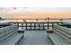 A tranquil waterfront sunset featuring a scenic dock with benches and calming water at 100 Bluff View Dr # 317A, Belleair Bluffs, FL 33770